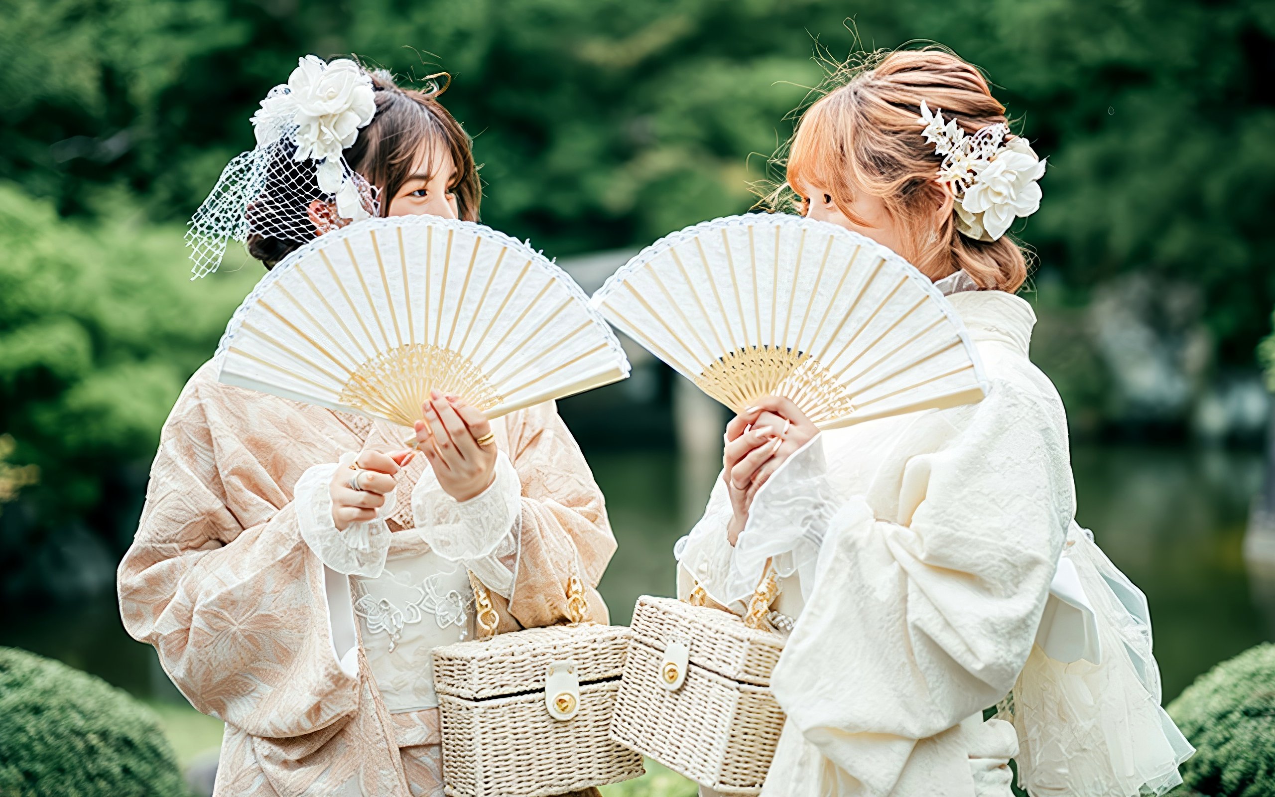 Individuals in traditional Japanese kimono holding fans during a rental experience.