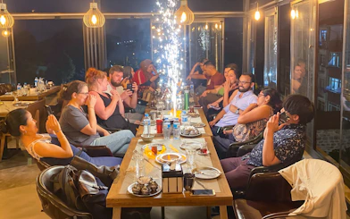 Guests dining at a Turkish Food Night event in Istanbul, seated around a table with sparklers.