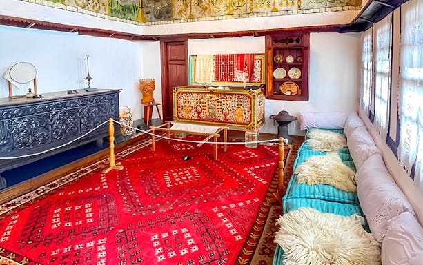 Exhibits inside Skanderbeg Museum featuring traditional Albanian decor and artifacts.