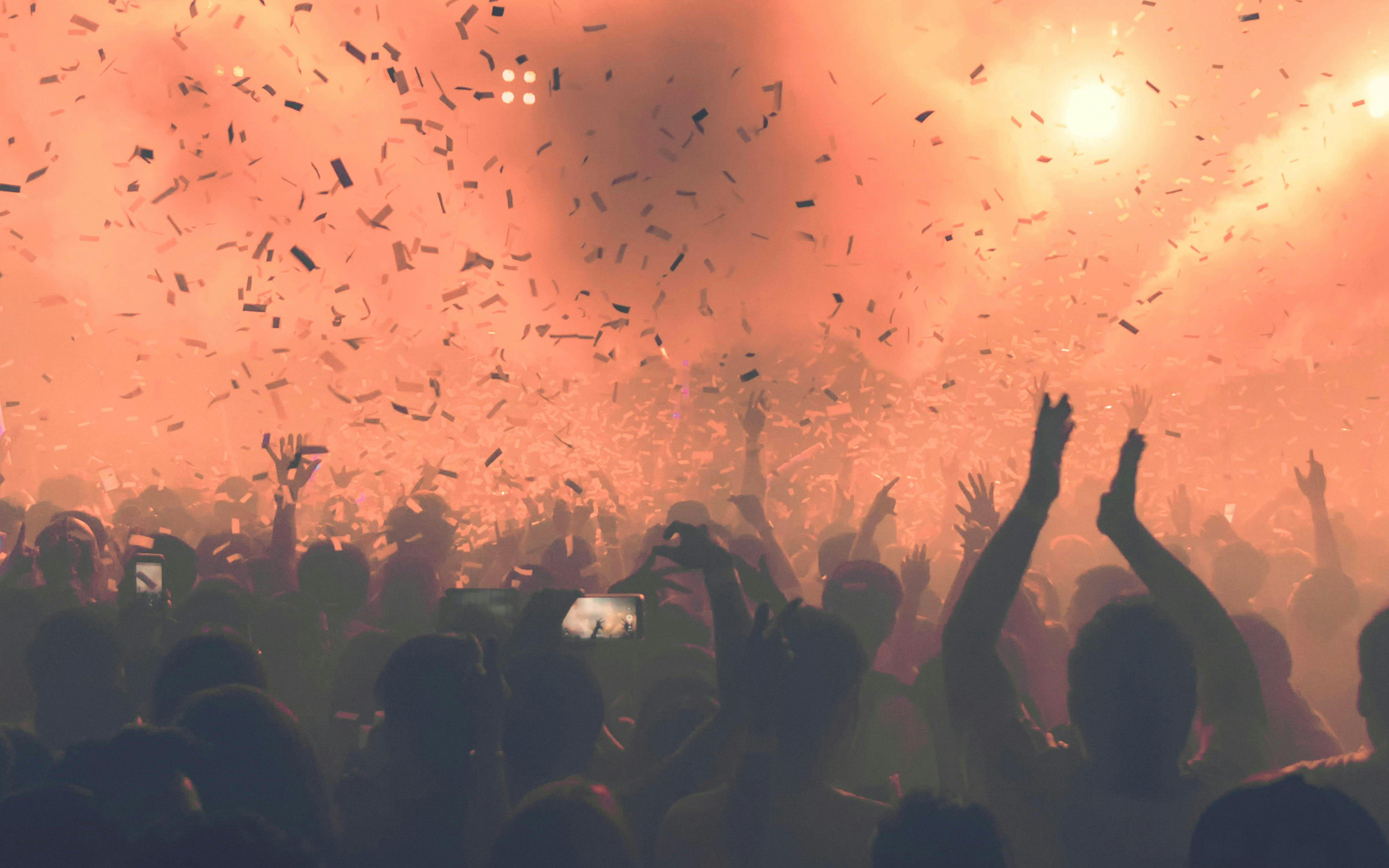 Crowd enjoying a vibrant party with confetti at 528 Ibiza.