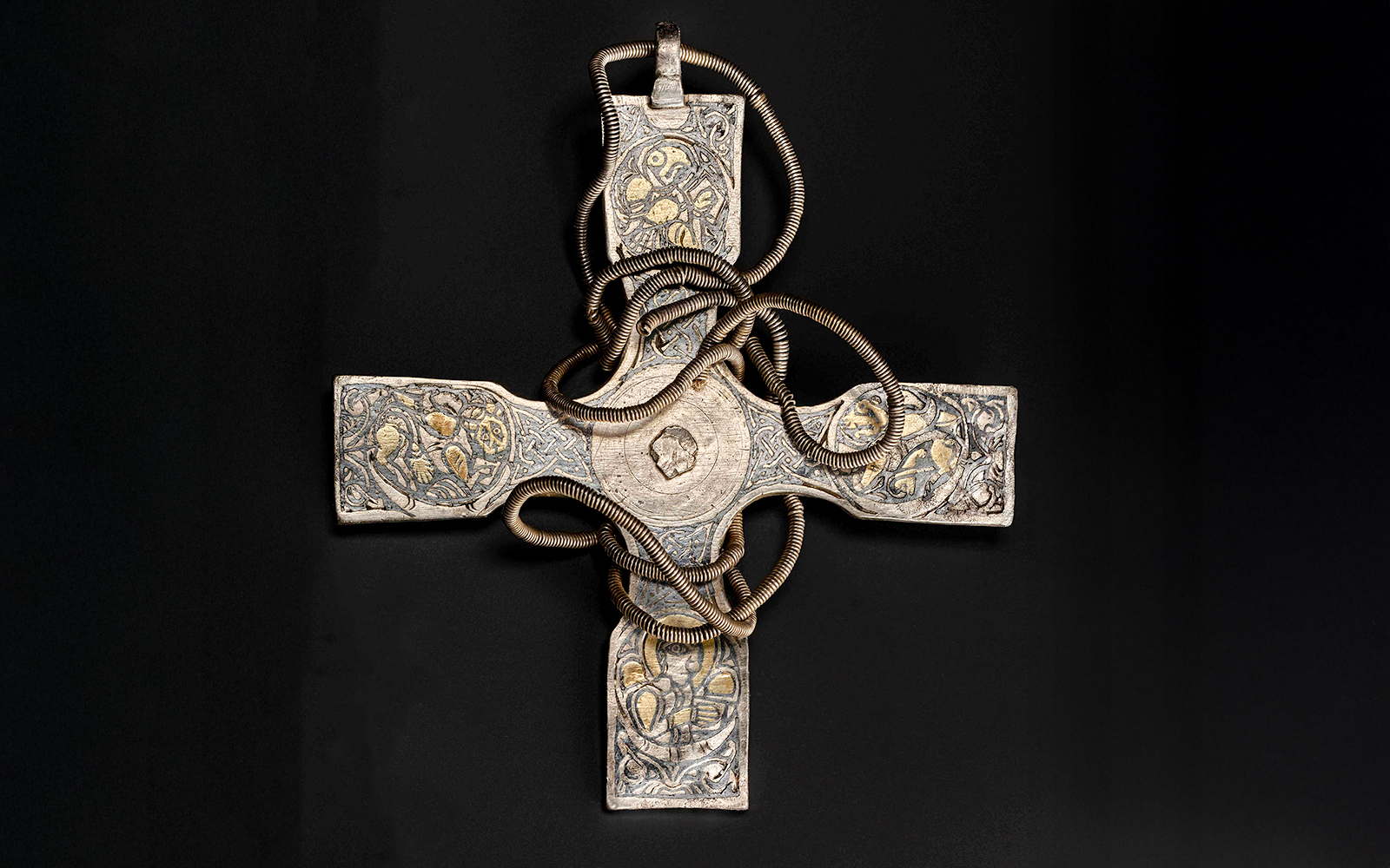 Viking Age pectoral cross with intricate designs and coiled metalwork.