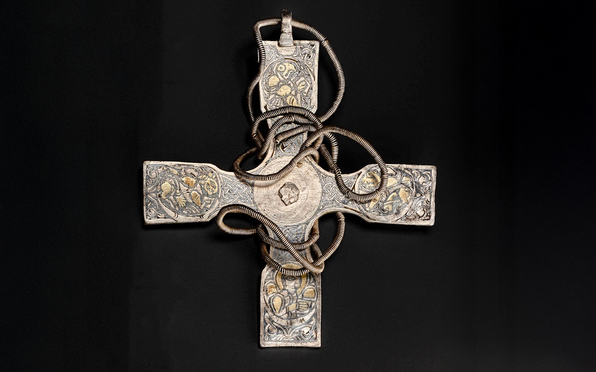 Viking Age pectoral cross with intricate designs and coiled metalwork.