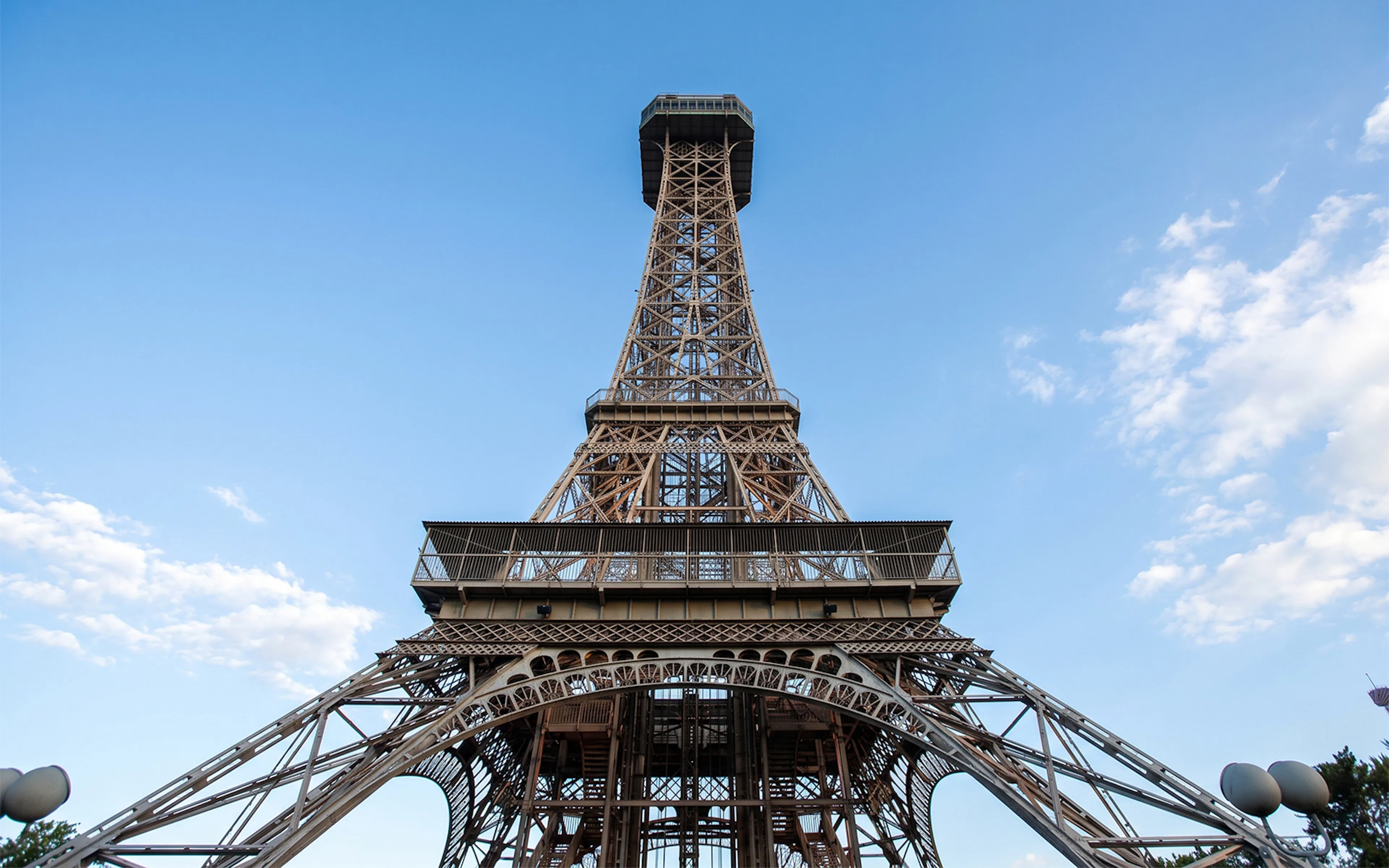 Eiffel Tower replica at King's Island, Six Flags against blue sky.