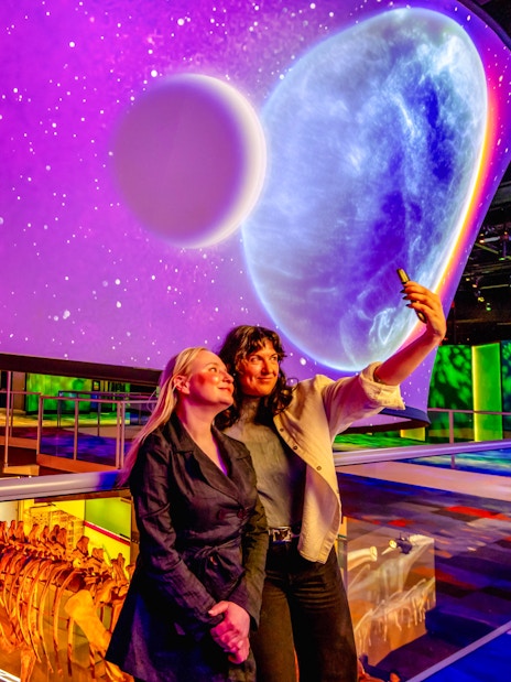 Visitors taking a selfie at the Our Wondrous Planet exhibit in Melbourne Museum.