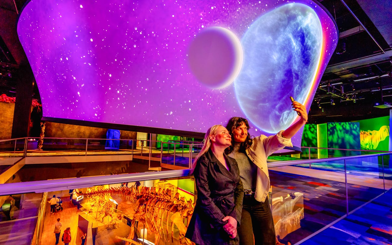Visitors taking a selfie at the Our Wondrous Planet exhibit in Melbourne Museum.