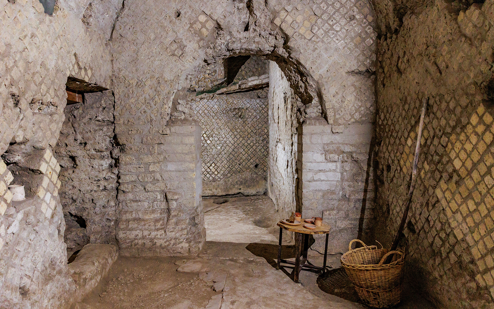Underground passageway in Neapolis Sotterrata with ancient stone walls and artifacts.