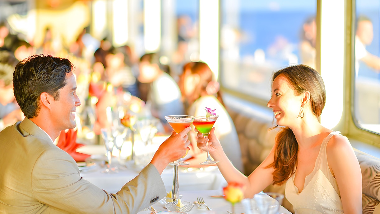 Couple toasting cocktails on Nova Five Star 2 cruise dining experience.