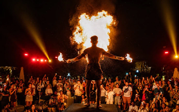 Fire performer entertaining crowd at Luna Beach Club.