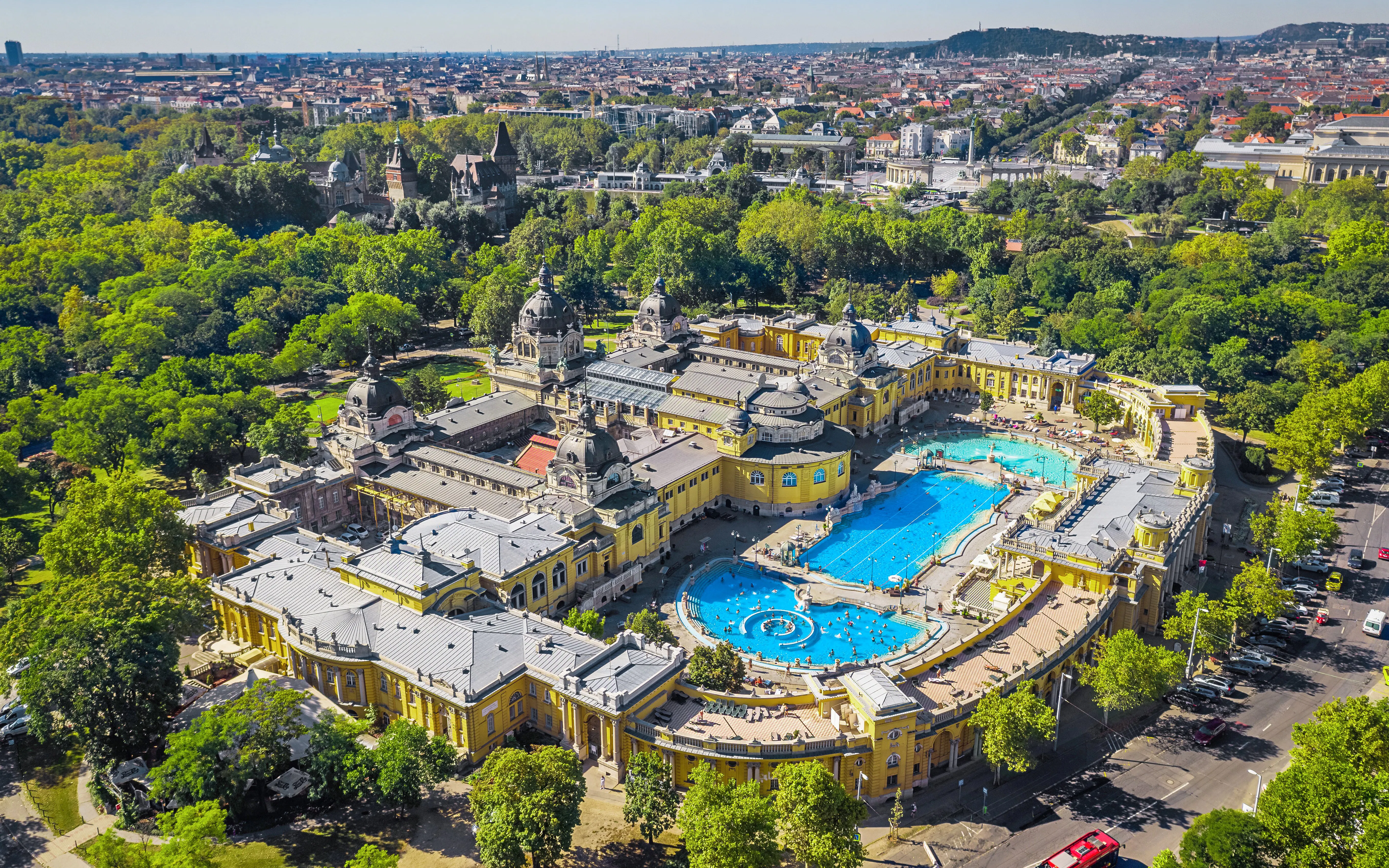 Aerial view of Széchenyi Baths in Budapest with surrounding cityscape.