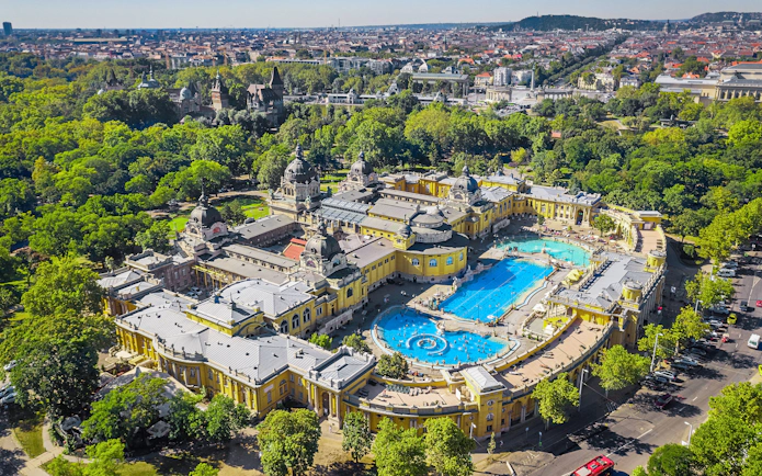 Aerial view of Széchenyi Baths in Budapest with surrounding cityscape.