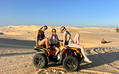 ATV riders on sand dunes during Mui Ne Jeep Tour, Ho Chi Minh City.