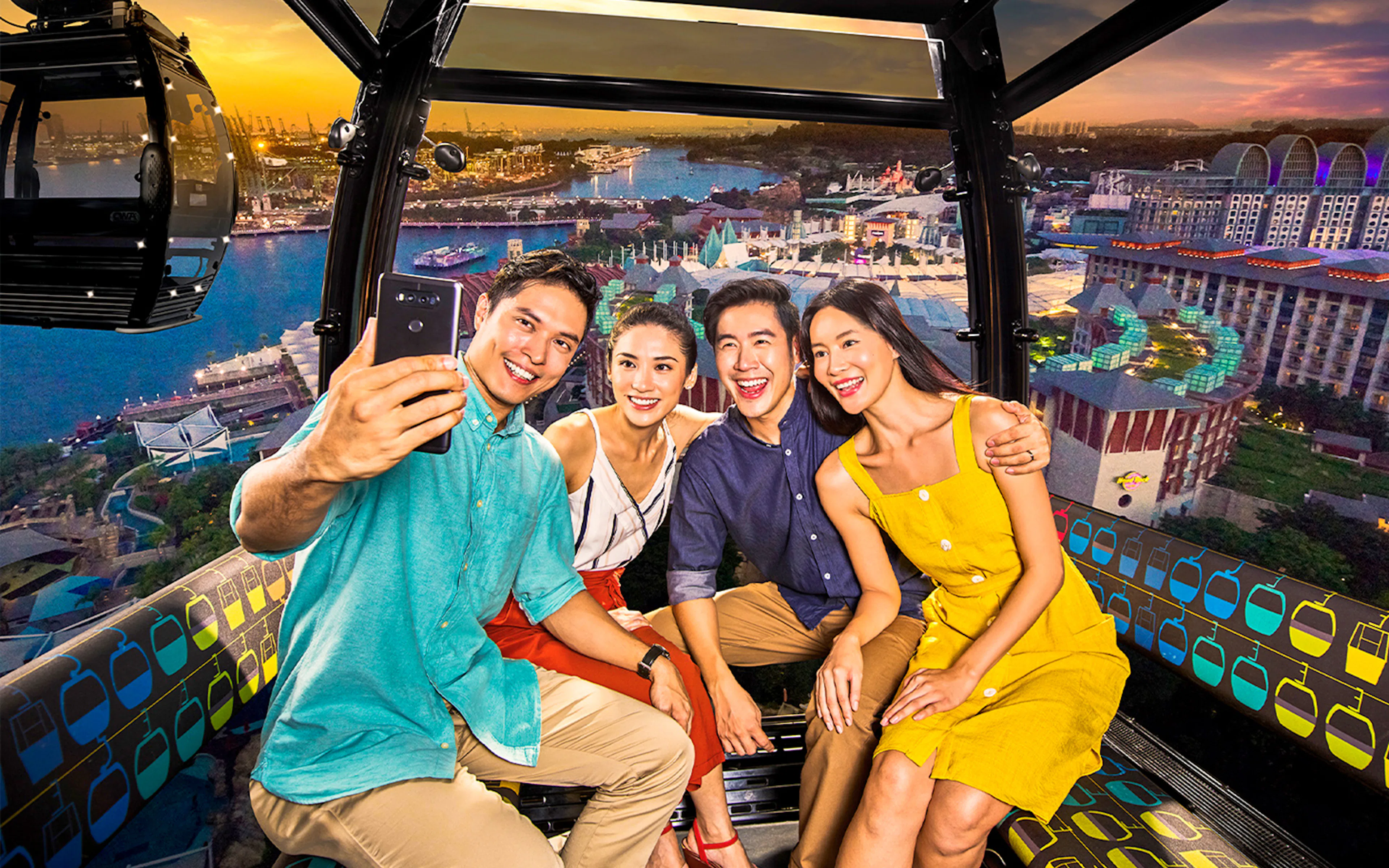 Passengers taking a selfie on the Singapore Cable Car with city skyline views.