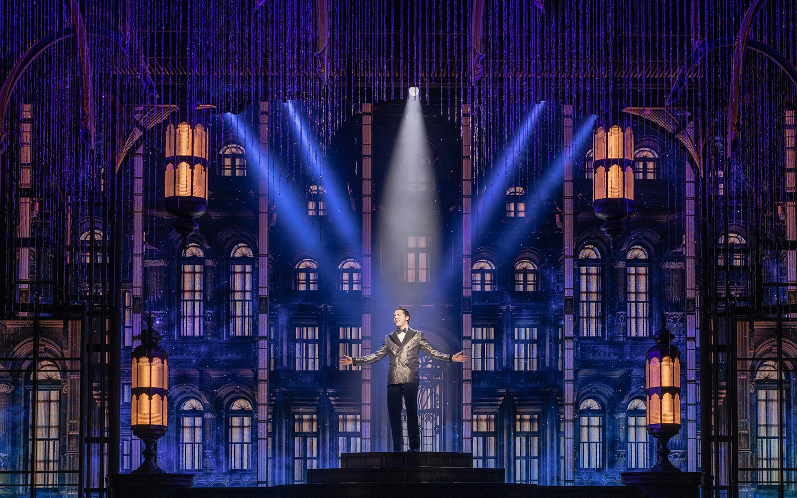 Performer on stage with art deco backdrop in The Great Gatsby show.