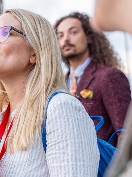 Tour group exploring Amsterdam's Red Light District with a guide.