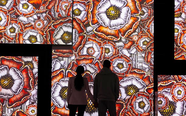 Visitors viewing floral digital art at Frameless National Portrait Gallery Exhibition.