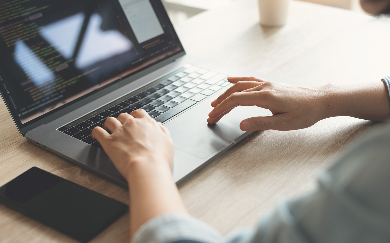 A man checking out the forecast website using his laptop, kept on his deck.