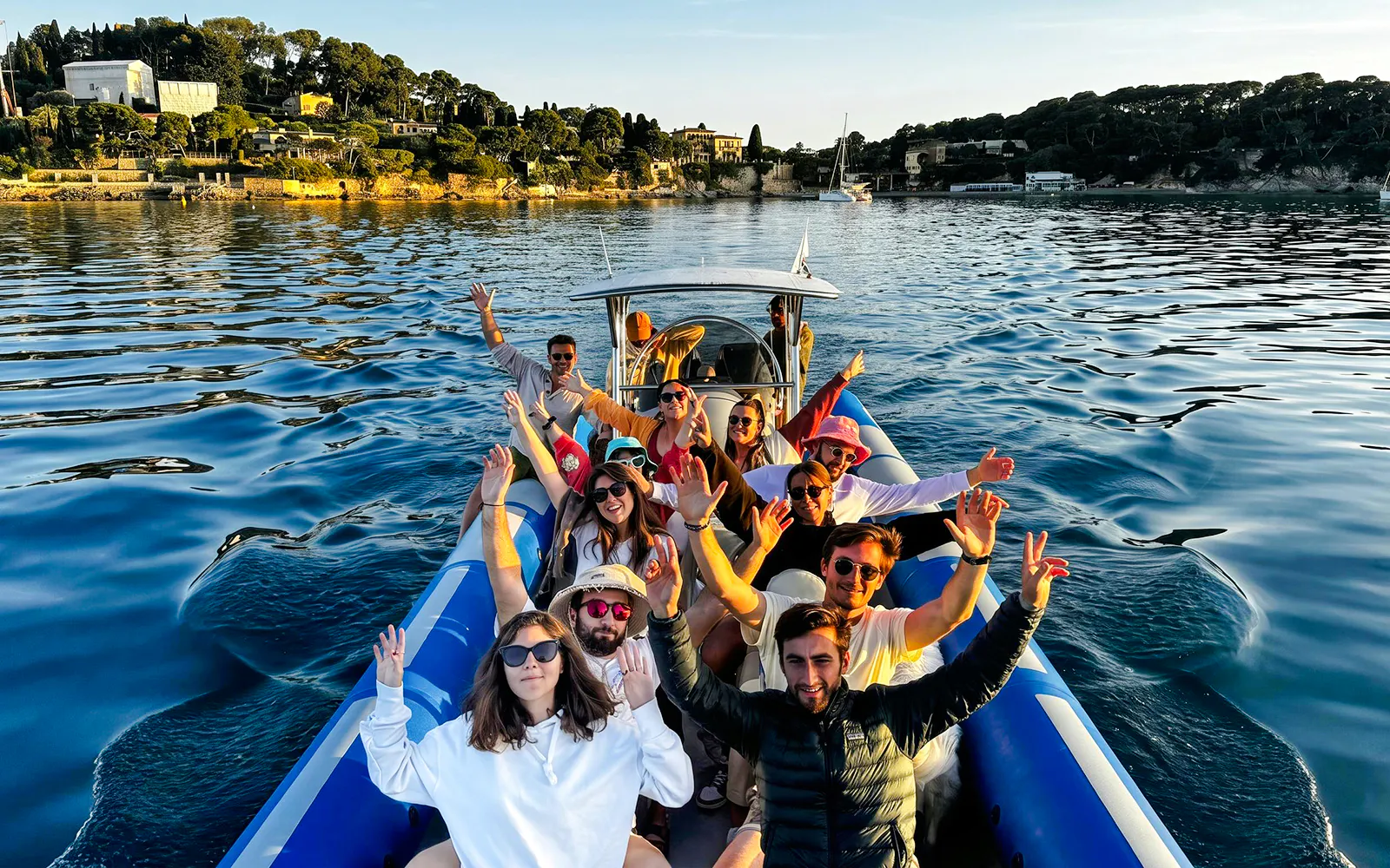Group enjoying a boat tour to Villefranche and Mala Cove, with scenic coastal views.