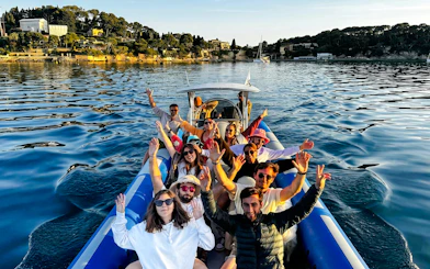 Group enjoying a boat tour to Villefranche and Mala Cove, with scenic coastal views.