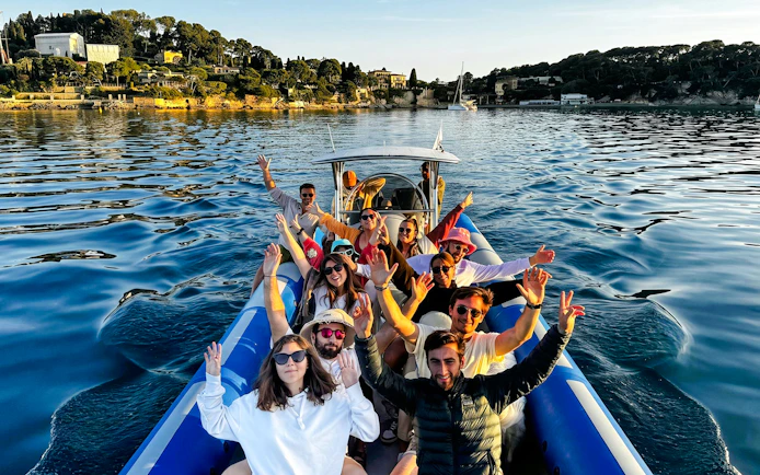 Group enjoying a boat tour to Villefranche and Mala Cove, with scenic coastal views.