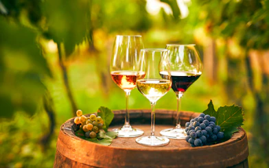 Wine glasses on a barrel with grapes during Vineyard & Wine Tasting tour in Cappadocia.