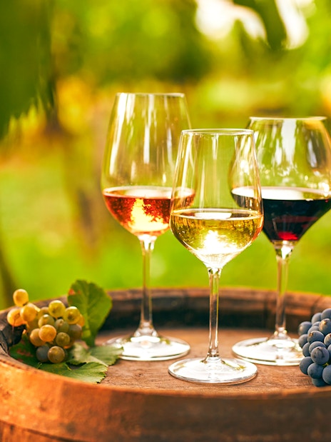 Wine glasses on a barrel with grapes during Vineyard & Wine Tasting tour in Cappadocia.