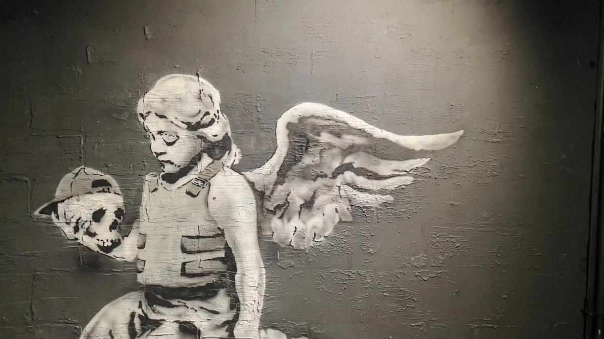 Angel holding a skull artwork at Banksy Museum, Amsterdam.