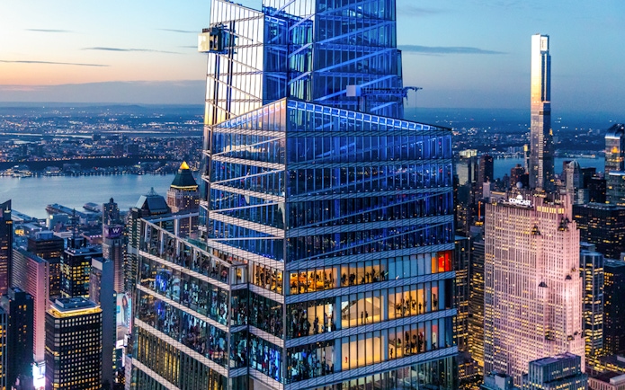 SUMMIT One Vanderbilt in New York City at dusk with city skyline.