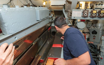 Visitors exploring the gun turret interior on the Battleship IOWA tour.