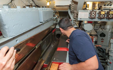 Visitors exploring the gun turret interior on the Battleship IOWA tour.
