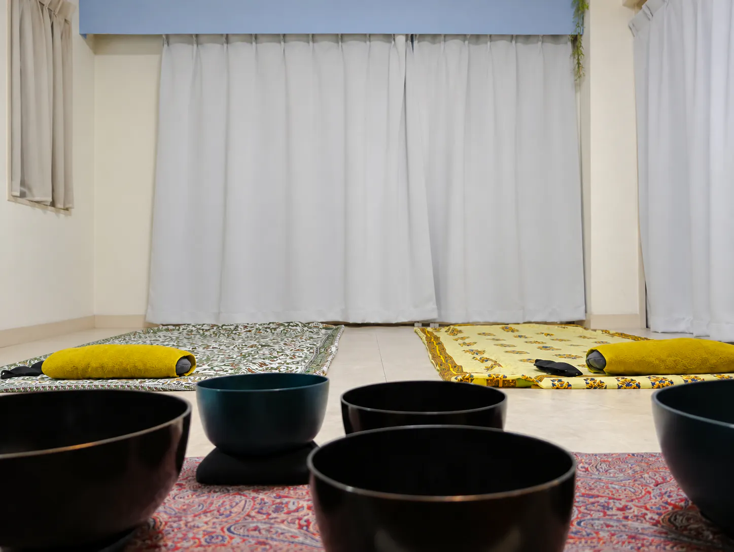 Meditation mats and sound bowls set up for a private Japanese sound bath in Kyoto.
