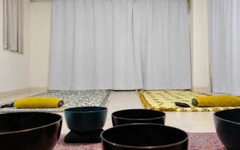Meditation mats and sound bowls set up for a private Japanese sound bath in Kyoto.