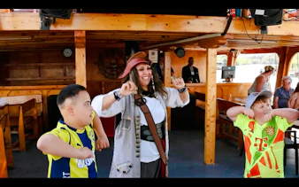 Kids dancing with pirate on ship during Antalya cruise tour.