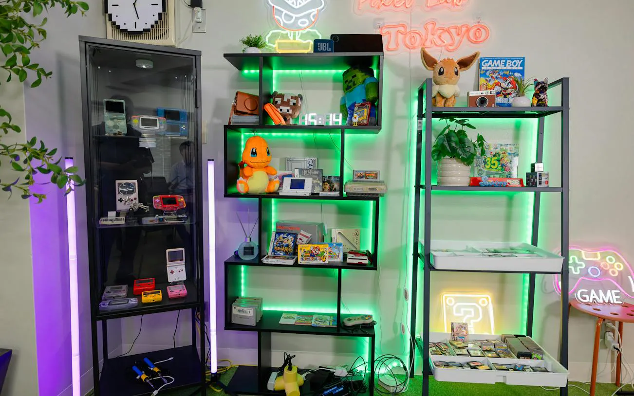 Game Boy consoles and retro gaming memorabilia at Pixel Lab Tokyo workshop.