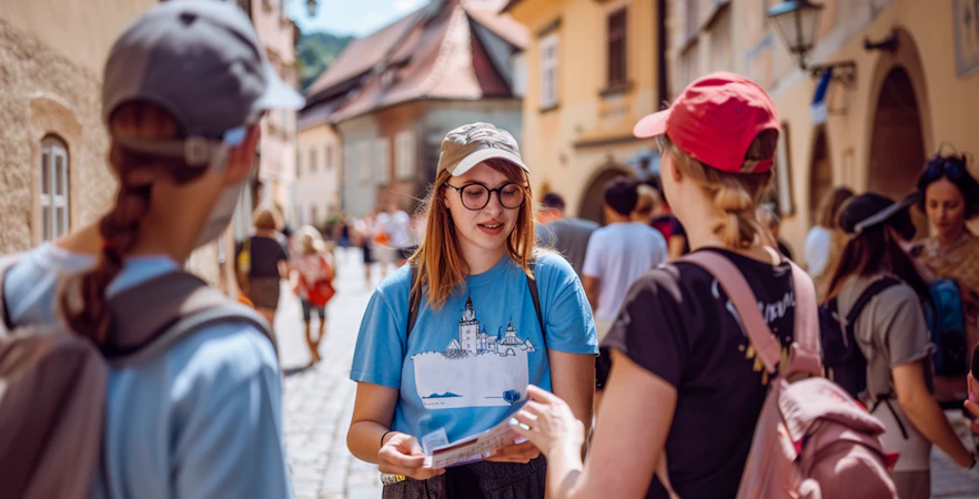 Tour guide explaining to tourists during a day trip from Prague to Český Krumlov.