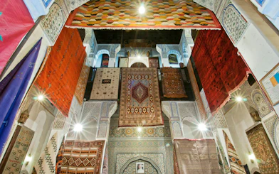 Colorful rugs hanging in a traditional shop in Fes Old Medina, Morocco.