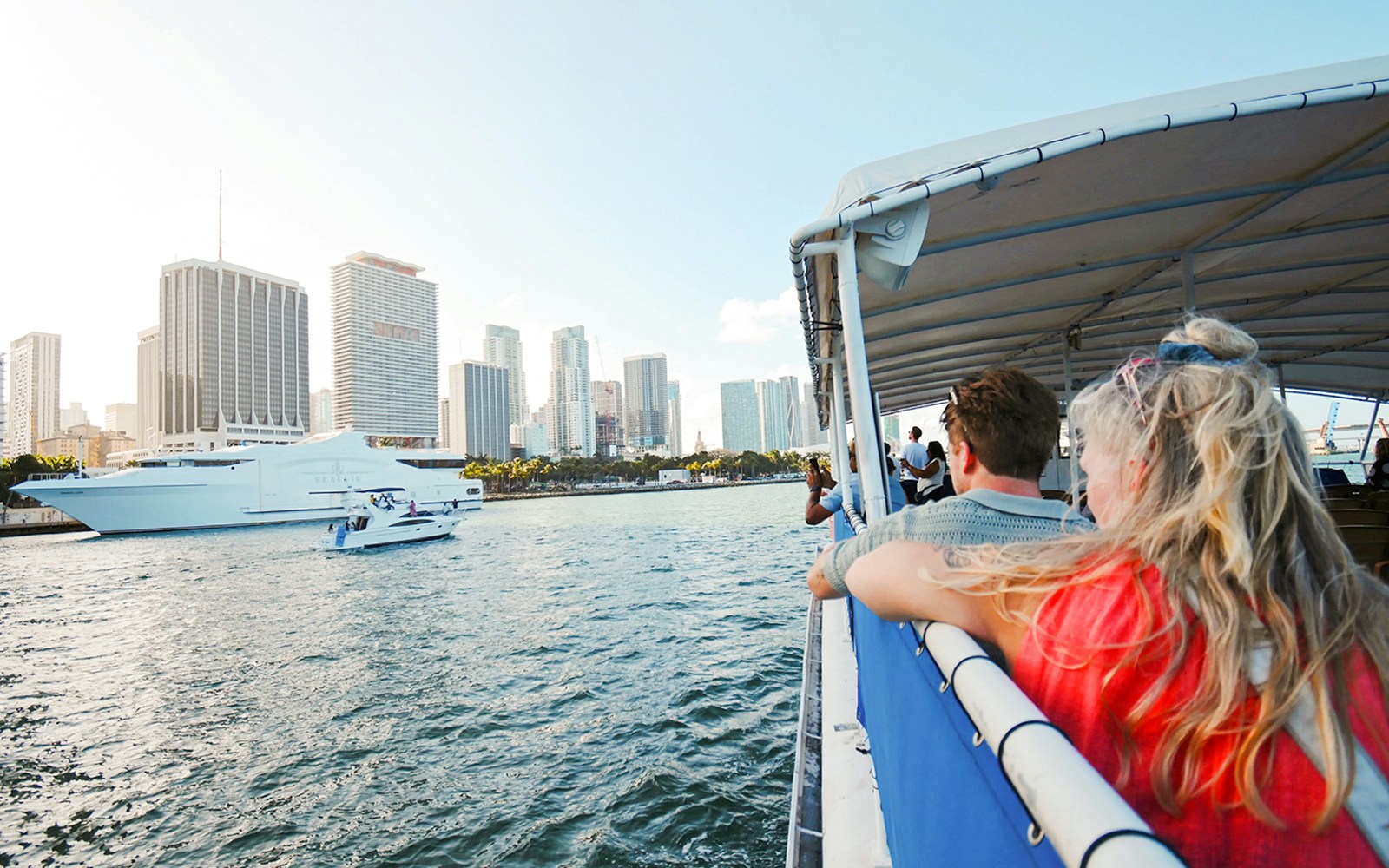 Guests enjoying a scenic cruise on the Seine River with views of the Eiffel Tower, Paris.