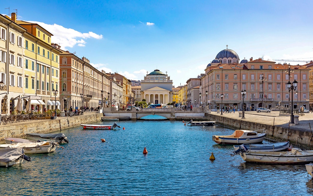 Trieste canal with boats and historic buildings on the Hoptour 24-hour hop-on hop-off route.