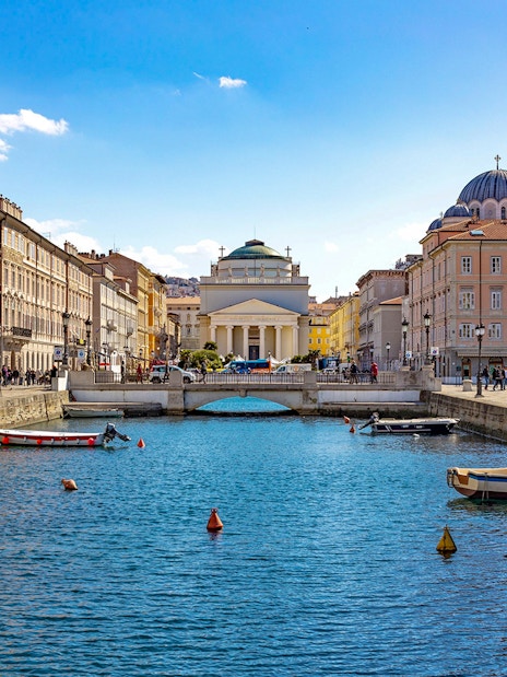 Trieste canal with boats and historic buildings on the Hoptour 24-hour hop-on hop-off route.