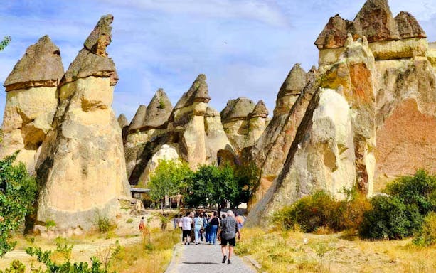 Guests walking through Pasabag Valley's unique rock formations in Cappadocia.