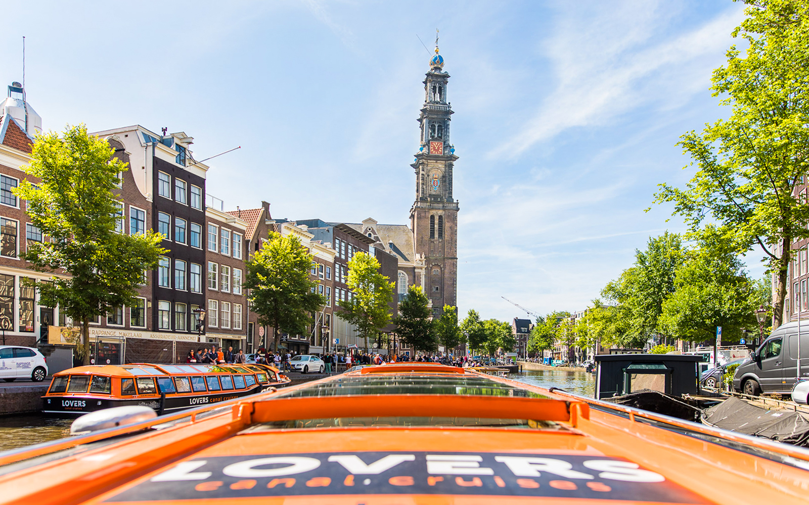 Amsterdam canal cruise with Westerkerk tower in view, part of City Sightseeing Hop on Hop off tour.