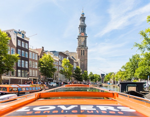 Amsterdam canal cruise with Westerkerk tower in view, part of City Sightseeing Hop on Hop off tour.