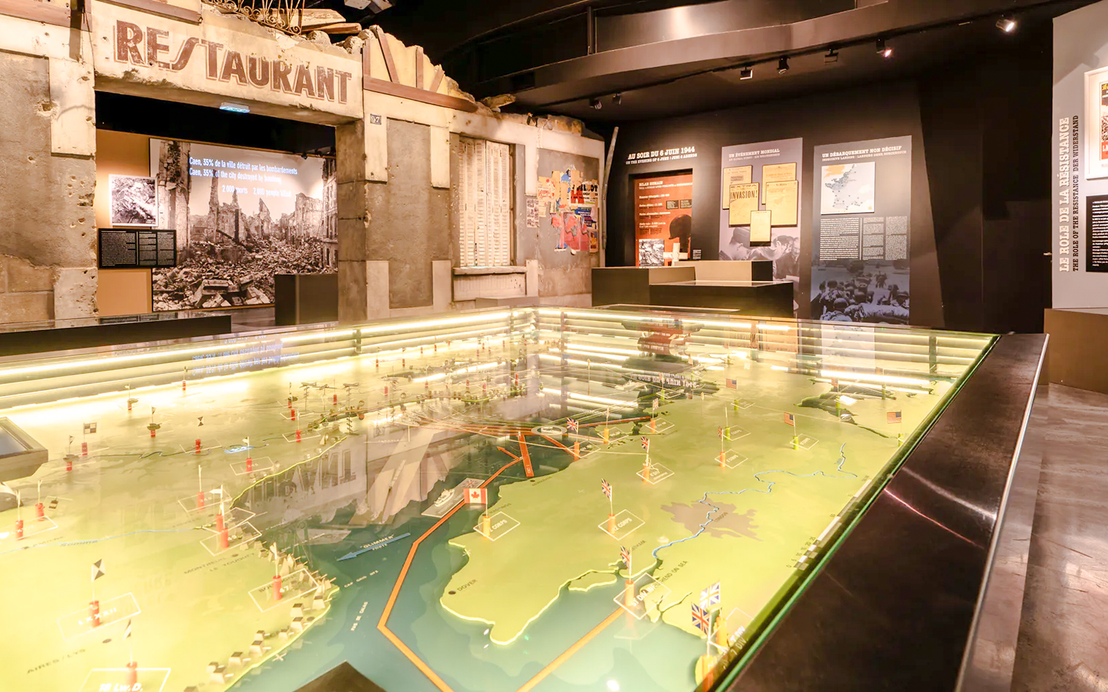 Exhibit at Caen Memorial Museum showing D-Day landing map and historical displays, France.