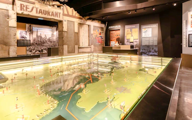 Exhibit at Caen Memorial Museum showing D-Day landing map and historical displays, France.
