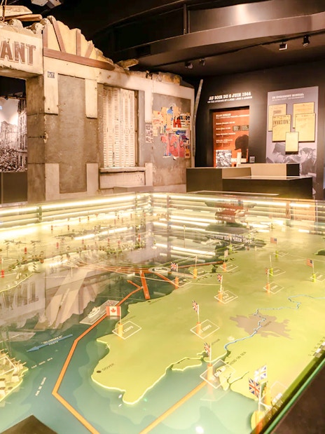 Exhibit at Caen Memorial Museum showing D-Day landing map and historical displays, France.