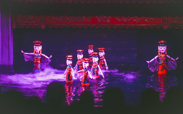 Water puppet performance in Ho Chi Minh City with colorful puppets on stage.
