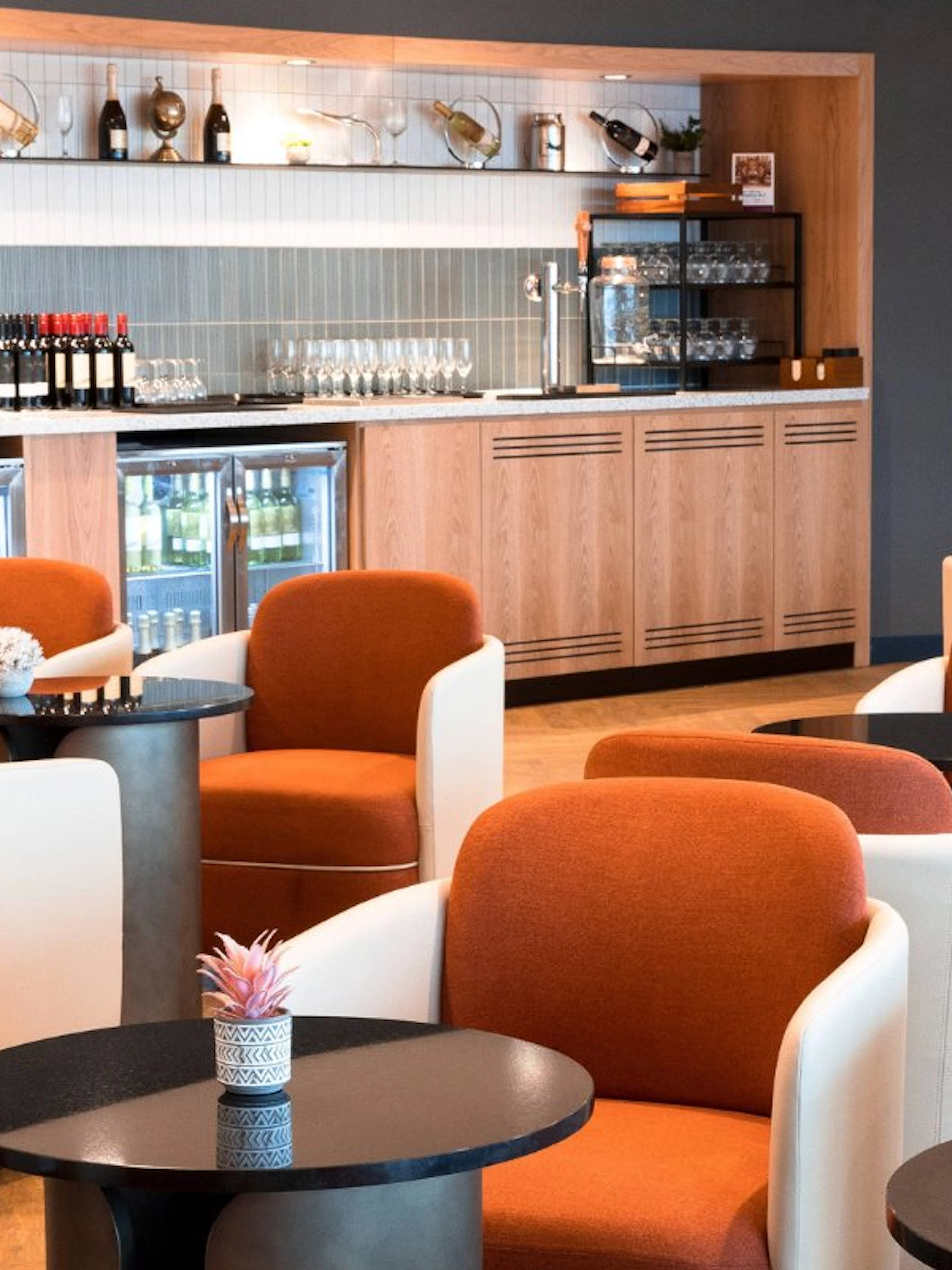 Plaza Premium Lounge seating area with bar at Terminal 4, London Heathrow Airport.