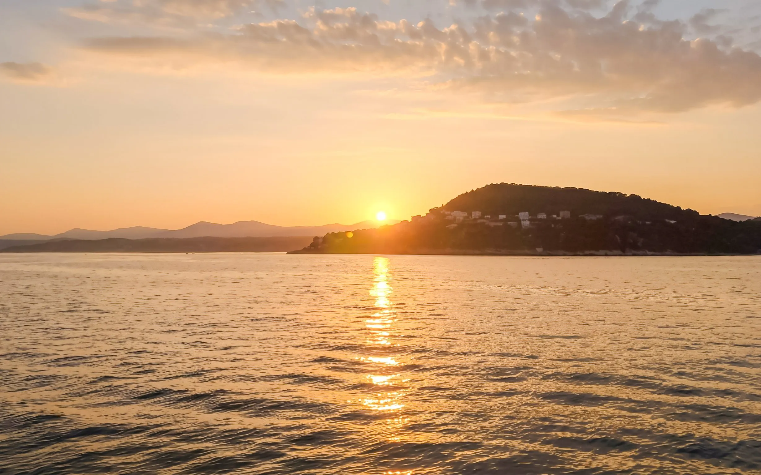 Sunset over the sea near Villefranche with silhouetted hills in the background.