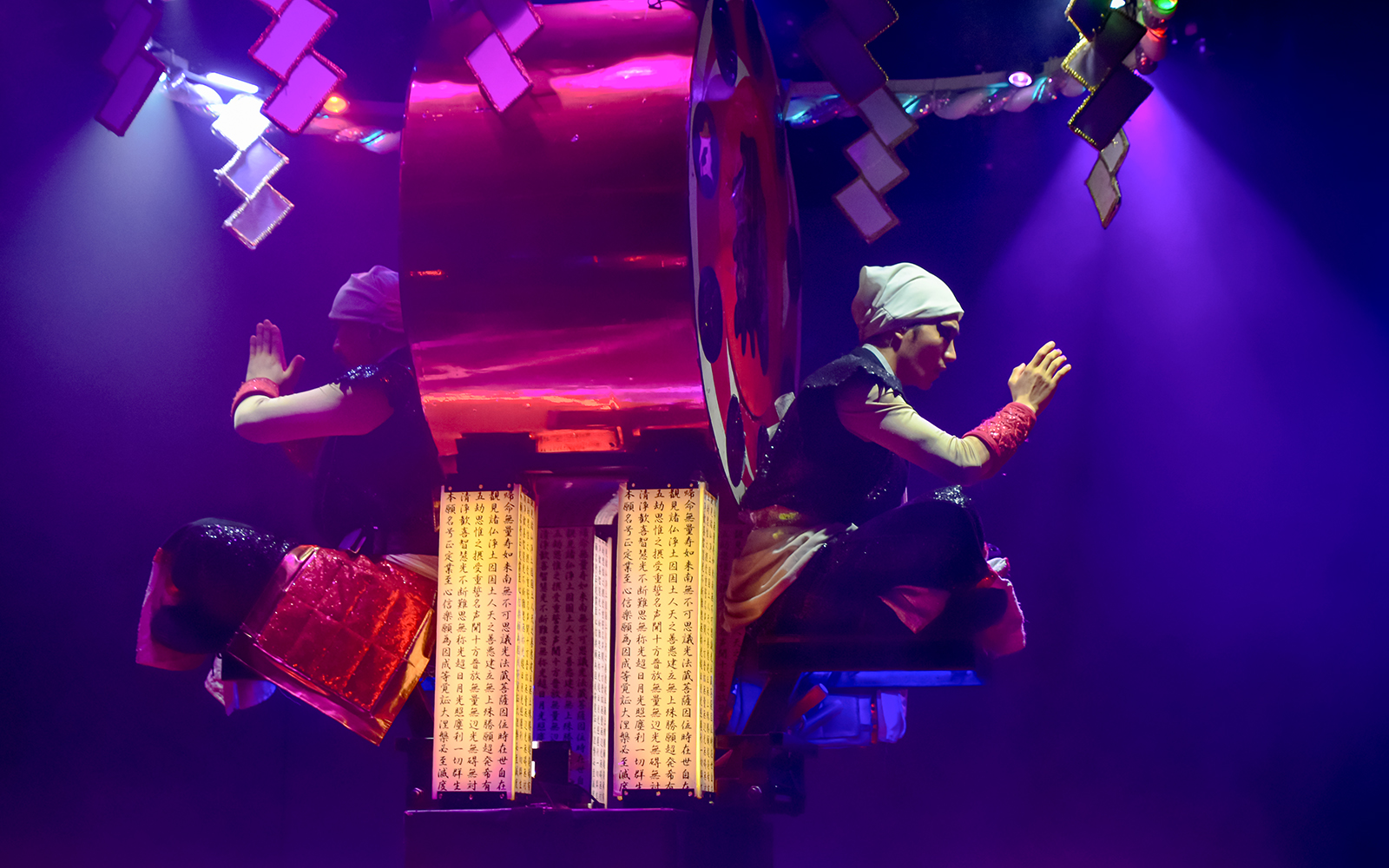 Performers in traditional attire during Samurai Restaurant Show in vibrant lighting.