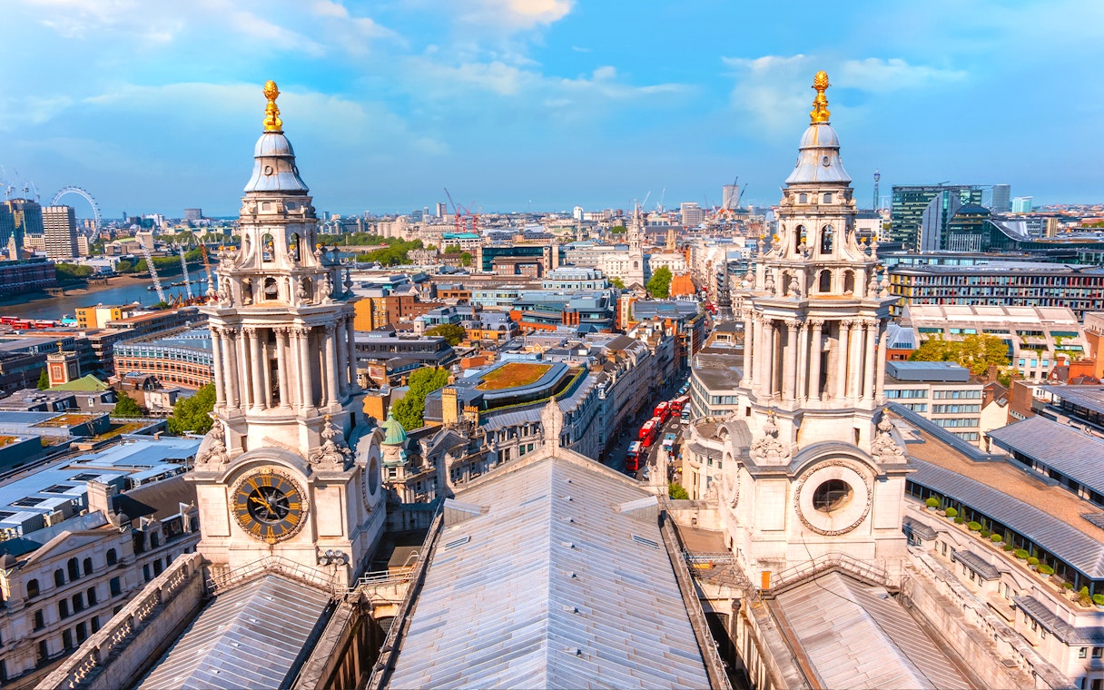 Aerial view from St Paul's Cathedral's Golden Gallery, showcasing twin baroque towers and London's skyline.