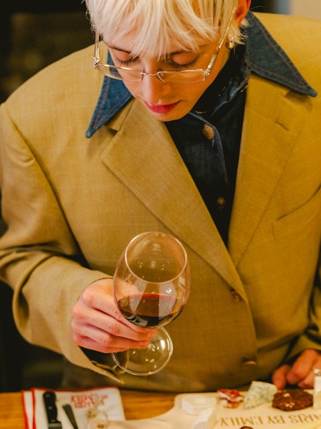 Couple tasting cheese and wine on Emily in Paris tour, Paris, France.